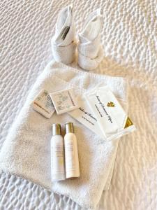 a group of products sitting on a towel on a bed at Divya Sutra Suites on Robson Downtown Vancouver in Vancouver