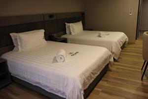 Voodi või voodid majutusasutuse Giluxe Hotel toas