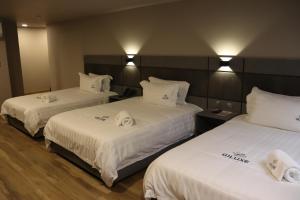 Voodi või voodid majutusasutuse Giluxe Hotel toas