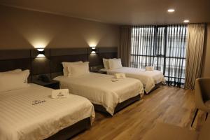 Voodi või voodid majutusasutuse Giluxe Hotel toas