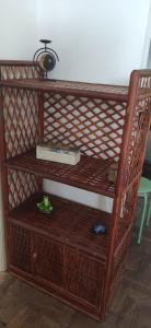 a wooden shelf with a book and a box on it at Apt para carnaval em Salvador in Salvador