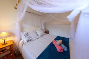Postel nebo postele na pokoji v ubytování Aconchego em Cumuru - Casa Cafuné