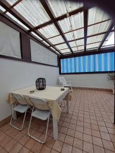 een tafel en stoelen in een kamer met een plafond bij Appartamento Bellaria-Igea Marina con terrazza in Bellaria-Igea Marina