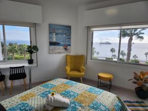a bedroom with a bed and a view of the ocean at Luxurious Kalypso in Limassol