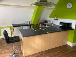 a kitchen with a counter with a sink and a microwave at ZenStay in Sunderland