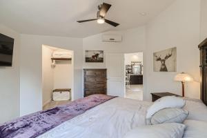 a bedroom with a large bed with a ceiling fan at 170 S Hoyt St in Lakewood