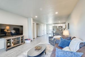 a living room with a couch and a tv at Convenient Great Falls Condo Less Than 1 Mi to Shops! in Great Falls