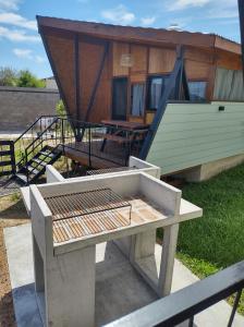 a house with a picnic table in front of it at Cabañas Posta Litoral in Colón