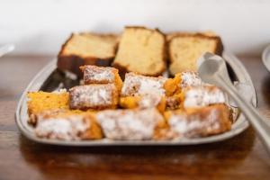 a plate of bread on a table with a spoon at Hotel Abadia in Gualeguaychú