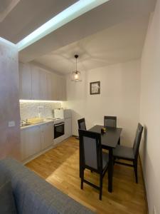 a kitchen and dining room with a table and chairs at Studio Snežana in Zlatibor