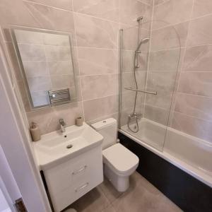a bathroom with a toilet and a shower and a sink at Apartment 20 min walk from Manchester City Centre in Manchester
