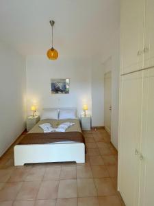 a bedroom with a bed and two lamps on two tables at Antonello House in Lixouri