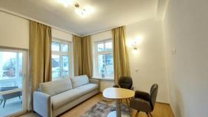 a living room with a couch and a table at Strandvilla Merva in Göhren