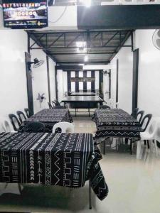 a room with two tables and chairs and a table with at D’HIDE OUT (place to have fun) in Cabanatuan