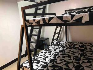 a bunk bed with a black and white at D’HIDE OUT (place to have fun) in Cabanatuan