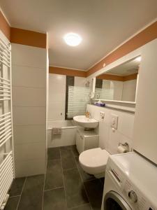 a white bathroom with a toilet and a sink at Apartment in Potsdam-Babelsberg in Potsdam