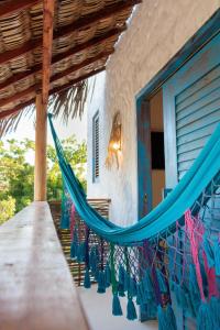 a hammock hanging on the side of a house at Casa Nature Atins in Atins