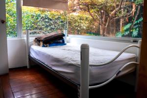 a hospital bed in a room with a window at Hostal Cuija Coyoacan Berlin 268 Coyoacan in Mexico City