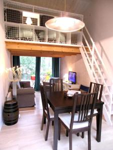 a living room with a table and a loft at Pretty house with double terrace near the ocean in Moliets-et-Maa
