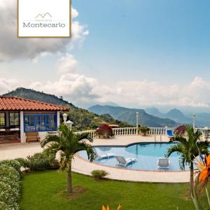 a resort with a swimming pool and mountains in the background at Finca Hotel Monte Carlos in Santa Bárbara +5 photos