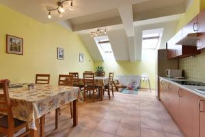 a kitchen and dining room with a table and chairs at Penzion U Zamku in Lednice