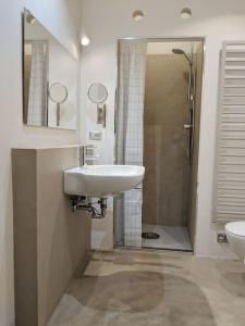 a bathroom with a sink and a shower at Atelier Relax Petit Turin - Centralissimo in Turin