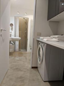 a bathroom with a washing machine and a sink at Atelier Relax Petit Turin - Centralissimo in Turin