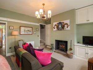 a living room with a couch and a fireplace at No 4 Embsay in Skipton