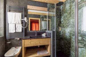 ein Bad mit einem Waschbecken und einer Dusche in der Unterkunft Hotel Columbia & Spa in Cortina d'Ampezzo