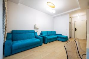 uma sala de estar com dois sofás azuis num quarto em Premier Luxury Apartment Lake On em Mamaia