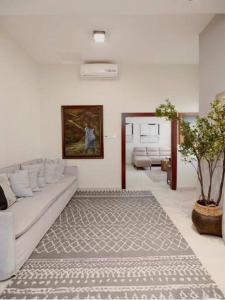 a living room with a white couch and a rug at Stylish 2 Bedroom in Osu in Accra