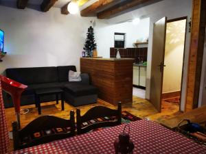 a living room with a couch and a christmas tree at Markov konak in Jahorina
