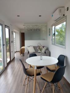 a living room with a table and chairs and a couch at Punto Alma Home box in San Rafael