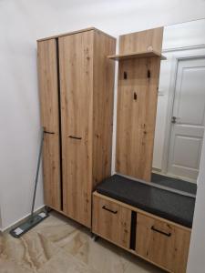 a wooden cabinet with a bed in a room at The Nest in Brăila