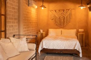 a bedroom with a bed and a couch in it at Privada y comoda cabaña, Casa Margarita, Villavieja in Villavieja