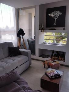 瓜塔佩的住宿－Palma Carey Colina View，客厅配有沙发,墙上挂着一棵树