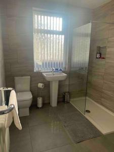 a bathroom with a sink and a toilet and a shower at Anfield Home Sleeps 5 Close to LFC free parking in Liverpool