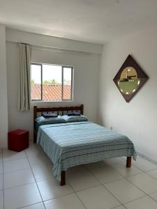 a bedroom with a bed and a window at Pousada Alto Mar in Matinhos