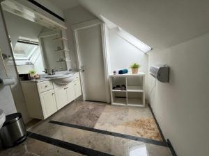 a small bathroom with a sink and a mirror at Maison Isa in Lommel