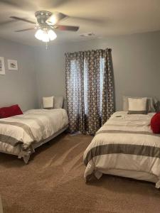1 dormitorio con 2 camas y ventilador de techo en Spacious Home Near Shaw, en Sumter