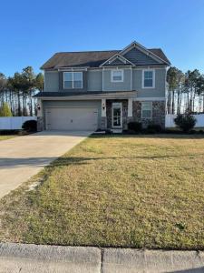 a large house with a large yard with a garage at Spacious Home Near Shaw in Sumter