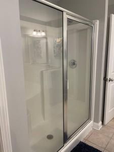 a shower with a glass door in a bathroom at Spacious Home Near Shaw in Sumter