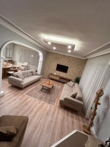 a living room with two couches and a flat screen tv at Villa Five Star in Sapanca