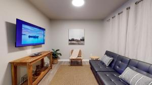 a living room with a blue couch and a tv at Emily's Escape AC Smart TV and Covered Parking in Snohomish
