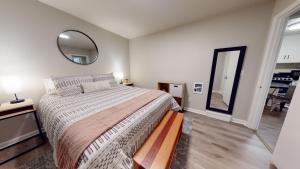 a bedroom with a large bed and a mirror at Emily's Escape AC Smart TV and Covered Parking in Snohomish