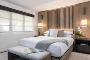 a bedroom with a large white bed and a window at Stilwell Hotel in Carmel