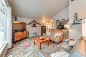 a living room with a couch and a table at Spacious Kenai Vacation Rental with Lake Access! in Kenai