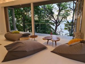 a room with two beds and a large window at The Headland Villa 2, Samui in Koh Samui