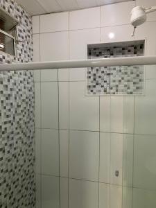 a bathroom with a shower with white tiles at Pousada Suítes Do Pelô in Salvador +88 photos