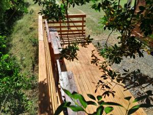 a wooden bridge with plants on it in a garden at El Arrayán in Lago Ranco